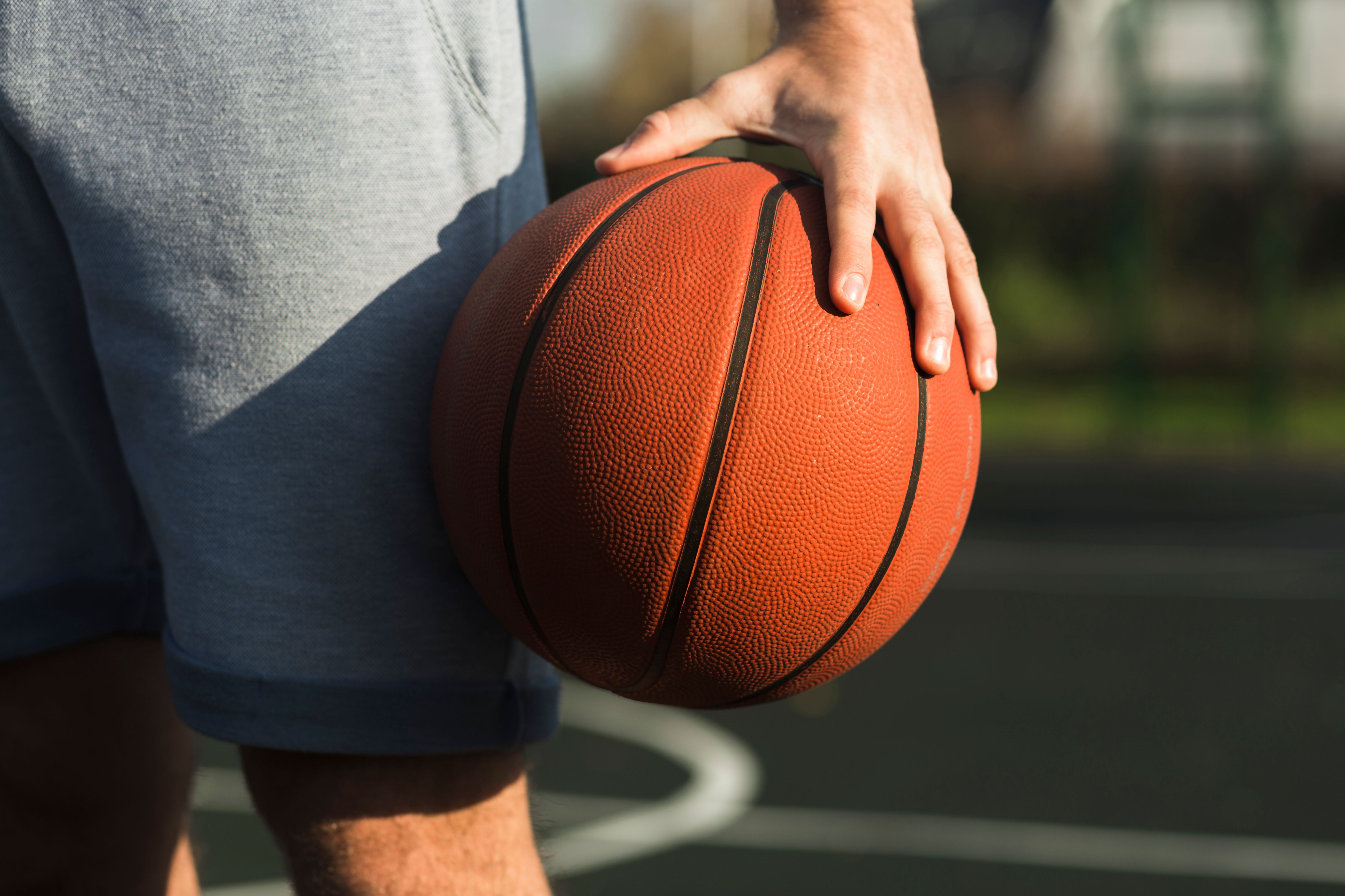 unrecognisable-male-holding-basketball.jpg